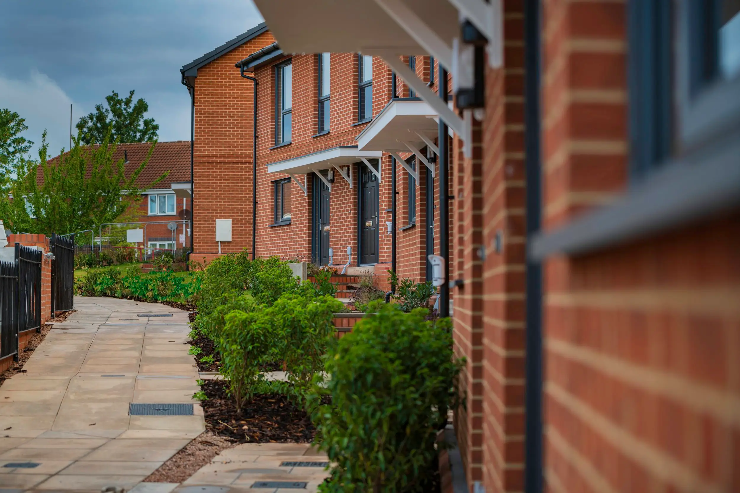 Planted frontages and entrance canopies along the new homes